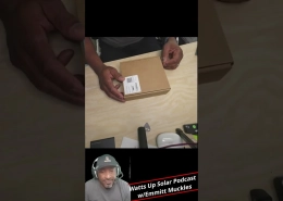 Hands unboxing a small brown cardboard box on a light wooden table, label visible on the box.
