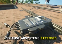 Gray APSystems solar inverter mounted on a shingled roof with multiple cables connected to a rail system.