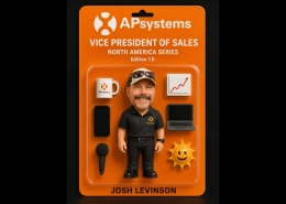 Orange APsystems packaging with a mini Josh Levinson figure, logo mug, laptop, microphone, upward-trending chart icon, sun emoji, and his name.