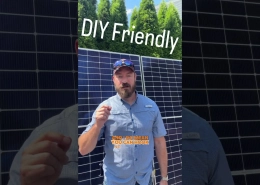Man in a blue shirt stands in front of solar panels, with overlay text 'DIY Friendly' and 'AND I DO MEAN YOU CAN HOOK UP'—emphasizing DIY solar hookup.